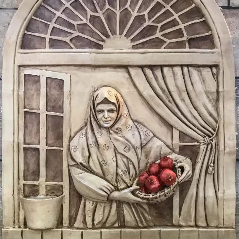 A woman holding a basket of pomegranates looking out of the window.